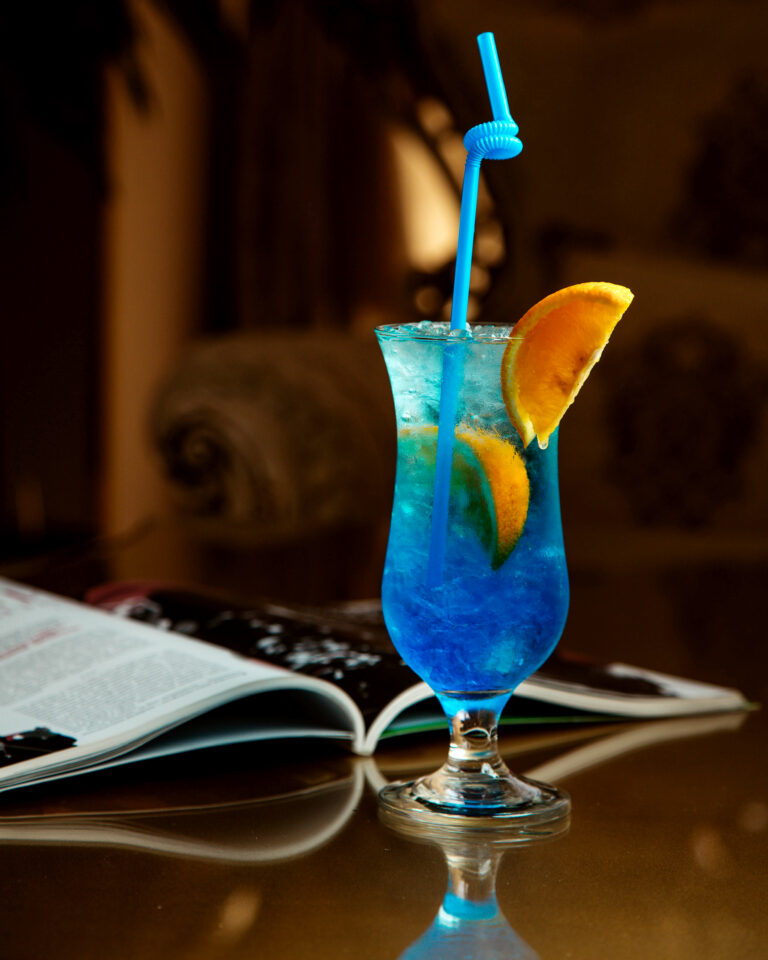 cold drink of blue color with a slice of orange
